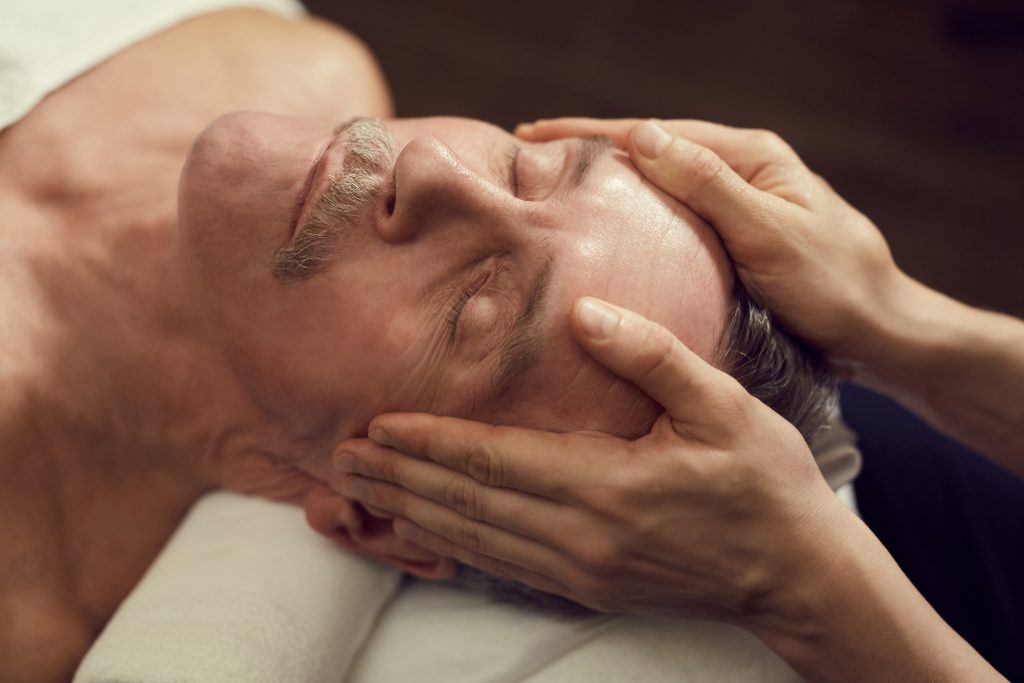 Senior Man Enjoying Facial Massage in SPA